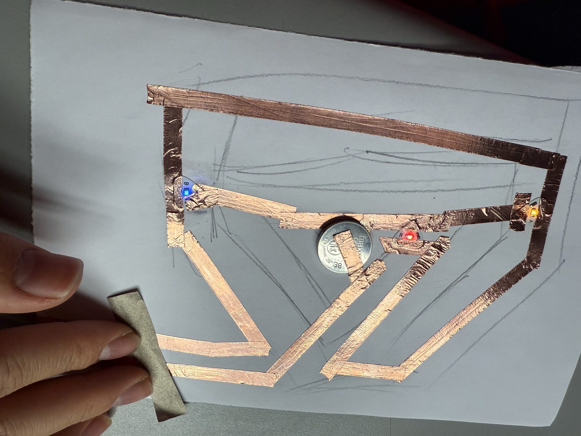 Using copper tape to create a conductive path for an LED circuit.