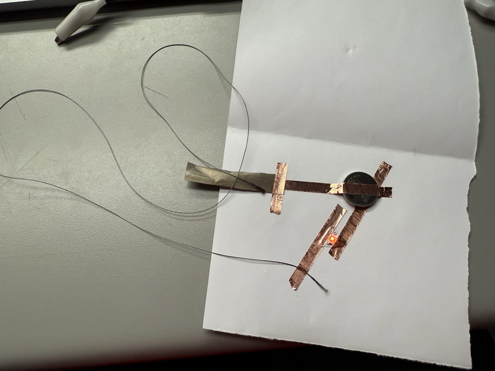 Detailed view of copper tape+Conductive thread and fabric connections in a circuit.