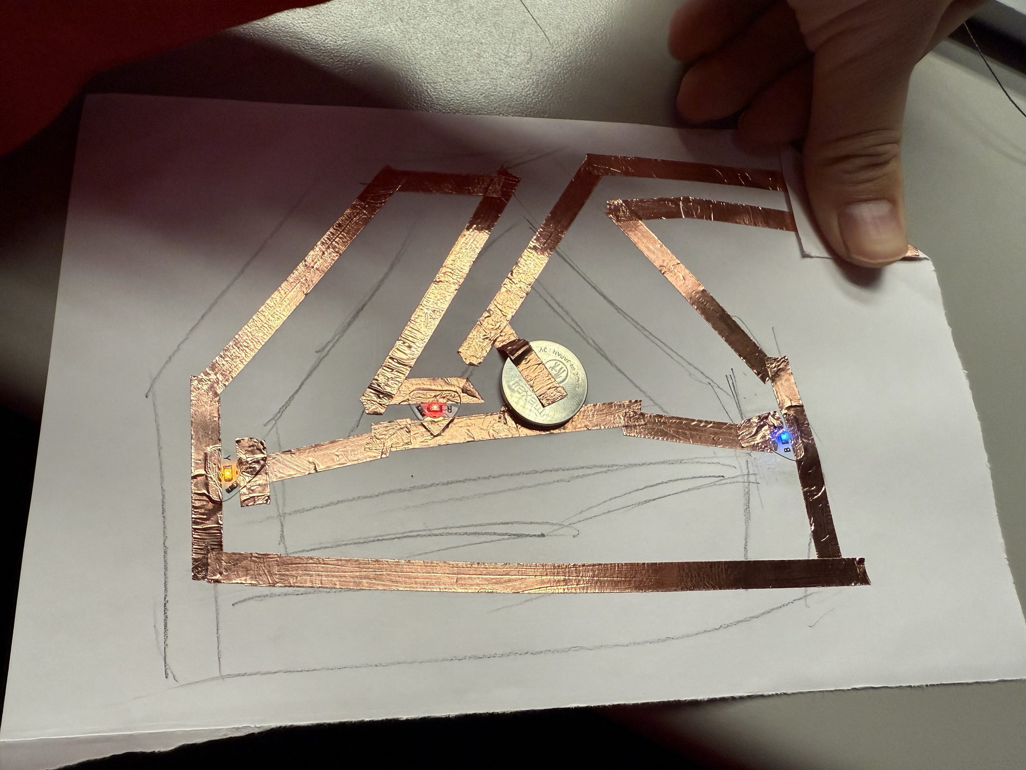 LED stickers in various colors connected with copper tape paths.