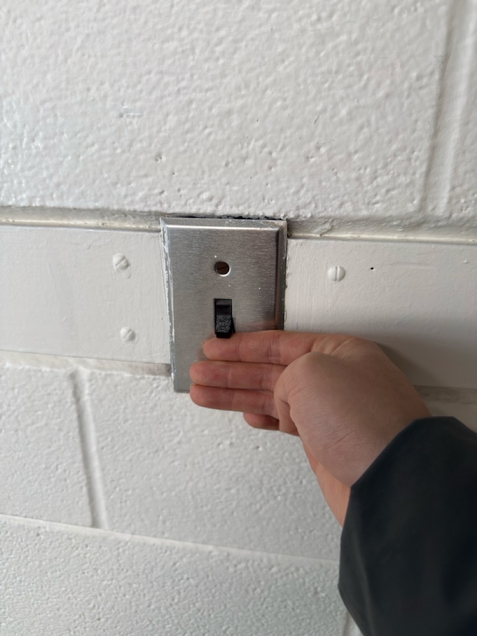 Hand flipping a light switch